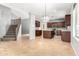 Open-concept kitchen with modern appliances, central island, and adjacent staircase at 10452 E Florian Ave, Mesa, AZ 85208