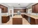 Well-equipped kitchen with central island, granite counters, and stainless steel appliances at 10452 E Florian Ave, Mesa, AZ 85208