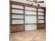 Cozy sitting room featuring a custom wall-mounted bookcase and tile flooring at 10452 E Florian Ave, Mesa, AZ 85208