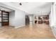 Open-concept living room with tile floors leading to kitchen and staircase at 10452 E Florian Ave, Mesa, AZ 85208