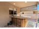 Stylish outdoor bar area featuring a granite countertop, sink, and custom wood finish, ideal for entertaining guests at 10452 E Florian Ave, Mesa, AZ 85208