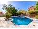 Sparkling blue pool with mature trees and lush foliage, perfect for relaxation and outdoor fun at 10452 E Florian Ave, Mesa, AZ 85208