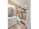 Updated bathroom with a modern vanity, decorative mirror, and a walk-in shower with tiled walls at 10624 W Oakmont Dr, Sun City, AZ 85351