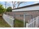 Fenced backyard with a charming white picket fence and a combination of brick and chain-link fencing at 1109 E 8Th St, Mesa, AZ 85203