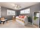 Bedroom features gray walls and floors, two windows, ceiling fan, full body mirror, and a platform bed with storage drawers at 1109 E 8Th St, Mesa, AZ 85203