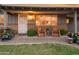 Inviting front porch with brick accents, potted plants, and rocking chairs, creating a cozy and welcoming entrance at 1109 E 8Th St, Mesa, AZ 85203