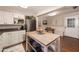 Functional kitchen featuring white cabinets, island prep space and stainless steel refrigerator next to breakfast nook at 1109 E 8Th St, Mesa, AZ 85203