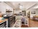 Well-lit kitchen with white cabinets, stainless steel appliances, and an island; seamlessly flows to dining area at 1109 E 8Th St, Mesa, AZ 85203