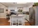 Efficient kitchen showcasing white cabinets, modern stainless steel appliances, and a functional island with seating at 1109 E 8Th St, Mesa, AZ 85203