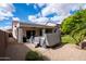 Spacious backyard featuring a covered patio, hot tub, and desert landscaping, ideal for outdoor living and entertaining at 11207 N 165Th Ave, Surprise, AZ 85388