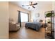 Comfortable bedroom featuring wood floor, accent chair, and bright light at 11207 N 165Th Ave, Surprise, AZ 85388