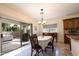 Dining area with sliding door leading to a patio and a view of the backyard at 11207 N 165Th Ave, Surprise, AZ 85388