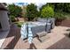 Hot tub on a brick patio, complete with steps and a towel rack, offering an inviting spa experience at 11207 N 165Th Ave, Surprise, AZ 85388