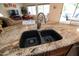 Modern kitchen sink with a stainless steel faucet and granite countertops in an open-concept space at 11207 N 165Th Ave, Surprise, AZ 85388