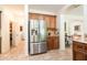 Kitchen featuring stainless steel fridge, wooden cabinetry and tile flooring at 11207 N 165Th Ave, Surprise, AZ 85388