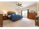 Cozy main bedroom features a ceiling fan, window, and carpeted floor at 11207 N 165Th Ave, Surprise, AZ 85388