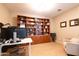 Comfortable home office with floor to ceiling bookshelves and a large window at 11207 N 165Th Ave, Surprise, AZ 85388