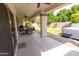 Covered patio with seating area, ceiling fan, and view of backyard at 11207 N 165Th Ave, Surprise, AZ 85388