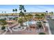 Relaxing community pool area with plenty of seating and shade, surrounded by palm trees at 11596 W Sierra Dawn Blvd # 99, Surprise, AZ 85378