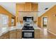 Kitchen featuring stainless steel appliances, cooktop, breakfast bar and light wood cabinets at 11596 W Sierra Dawn Blvd # 99, Surprise, AZ 85378