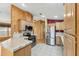 A view of the kitchen, with stainless steel appliances, light wood cabinets, and tiled floor at 11596 W Sierra Dawn Blvd # 99, Surprise, AZ 85378