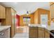 Kitchen and attached eating area with tile counters, wood cabinets, and an open concept layout at 11596 W Sierra Dawn Blvd # 99, Surprise, AZ 85378