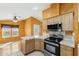 Kitchen with stainless appliances, tile counters, and an adjacent eating area with large windows at 11596 W Sierra Dawn Blvd # 99, Surprise, AZ 85378