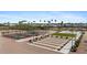 Community pickleball and shuffleboard courts with lush landscaping and seating for spectators at 11596 W Sierra Dawn Blvd # 99, Surprise, AZ 85378