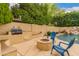 Backyard with built in grill and seating area surrounding a fire pit at 1165 E Erie St, Gilbert, AZ 85295