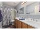 Bright bathroom featuring a double vanity, shower/tub and modern fixtures at 1165 E Erie St, Gilbert, AZ 85295