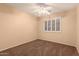 Neutral bedroom with a ceiling fan, window with shutters and neutral colored carpet at 1165 E Erie St, Gilbert, AZ 85295