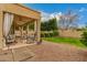 View of the covered patio with comfortable seating and a view of the neatly landscaped backyard and blue sky at 1165 E Erie St, Gilbert, AZ 85295