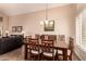 Dining room featuring a table and chairs, chandelier, and access to the living room at 1165 E Erie St, Gilbert, AZ 85295