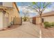 Exterior shot of a home showcasing a concrete driveway leading up to a wood driveway gate and the side of the house at 1165 E Erie St, Gilbert, AZ 85295