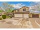 Attractive two-story home with a three-car garage, and well-maintained front yard at 1165 E Erie St, Gilbert, AZ 85295