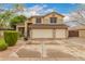 Two-story home with a three-car garage and well-maintained landscaping offers great curb appeal at 1165 E Erie St, Gilbert, AZ 85295