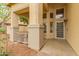 Inviting front porch features neutral tones, decorative columns, and a decorative security screen door at 1165 E Erie St, Gilbert, AZ 85295