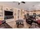 Spacious living room with tile flooring, built-in shelving, and an open view into the kitchen area at 1165 E Erie St, Gilbert, AZ 85295