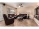 Inviting living room featuring tile floors, neutral walls, and comfortable leather seating at 1165 E Erie St, Gilbert, AZ 85295