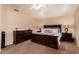 Spacious main bedroom with a large bed, plush carpet, and well-placed lighting at 1165 E Erie St, Gilbert, AZ 85295