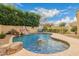 Backyard pool with rock waterfall feature and slide at 1165 E Erie St, Gilbert, AZ 85295