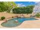 Backyard pool with rock waterfall feature at 1165 E Erie St, Gilbert, AZ 85295