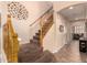 Carpeted staircase with wooden banister and decorative wall art at 1165 E Erie St, Gilbert, AZ 85295