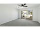 Bright bedroom featuring a ceiling fan, and a sliding glass door that fills the space with natural light at 122 S Hardy Dr # 6, Tempe, AZ 85281