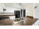 Well-lit kitchen with white cabinets, stainless steel sink, and modern appliances at 122 S Hardy Dr # 6, Tempe, AZ 85281