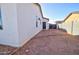 View of the spacious backyard and the exterior of the home with a secure fence at 12722 W Diaz Dr, Arizona City, AZ 85123