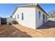 Side view of the backyard and exterior of the home with bright windows and secure fencing at 12722 W Diaz Dr, Arizona City, AZ 85123