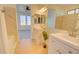 Bright, modern bathroom featuring dual sinks, a large mirror, and decorative tile at 12722 W Diaz Dr, Arizona City, AZ 85123