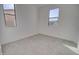 Carpeted bedroom featuring dual windows providing plenty of natural light at 12722 W Diaz Dr, Arizona City, AZ 85123