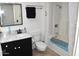 This bathroom features a shower-tub combo and a vanity with a stylish marble countertop at 13219 W Aleppo Dr, Sun City West, AZ 85375